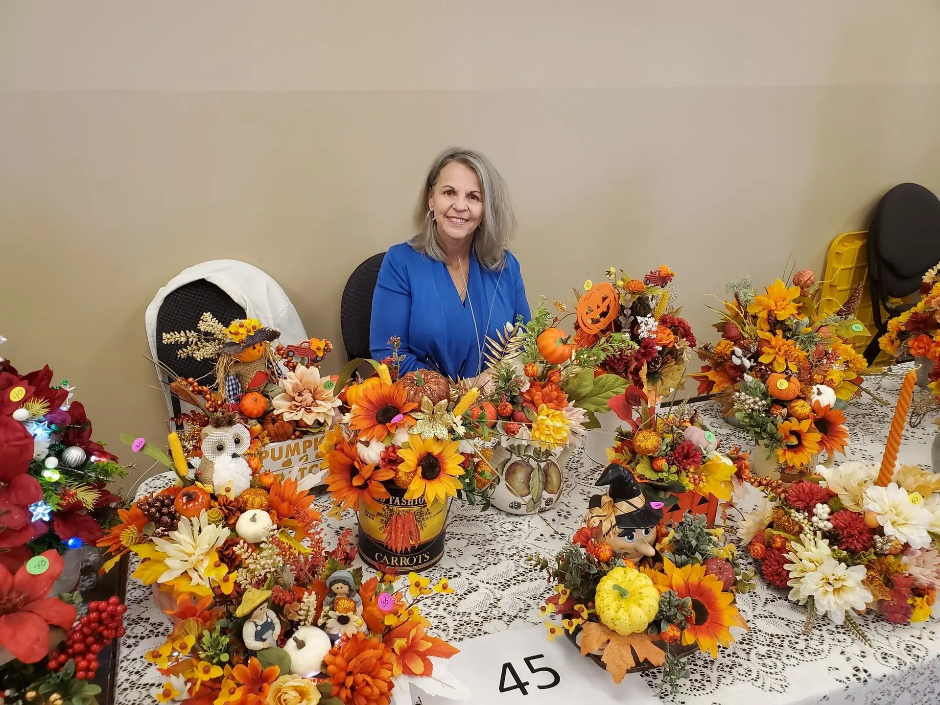 Image showing a participant displaying autumn themed flower arrangements